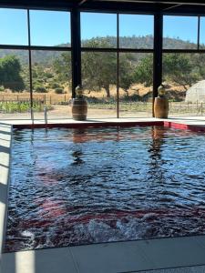 a swimming pool in a house with a large window at Hotel Boutique BC Wine Casablanca in Casablanca