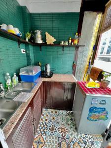 a small kitchen with a sink and a refrigerator at Warm Hanoi, near Hoankiem Lake, 2Brs, Old Quarter in Hanoi