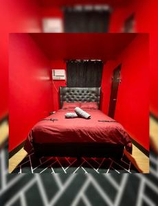 a red bedroom with a bed with a red wall at The Red Room 2bed room Condo in Imus