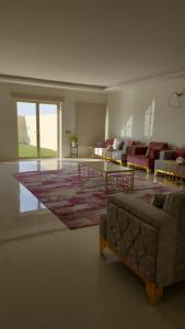 ein Wohnzimmer mit einem Sofa und einem Teppich in der Unterkunft استراحة الضيافة in Al-Dschubail