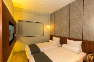 Postel nebo postele na pokoji v ubytování Nata Azana Hotel Solo