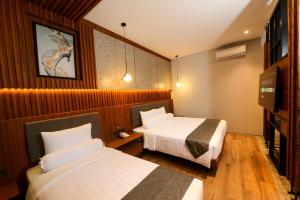 Postel nebo postele na pokoji v ubytování Nata Azana Hotel Solo