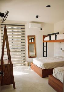 a bedroom with two bunk beds and a mirror at Casa Luni in Puerto Escondido