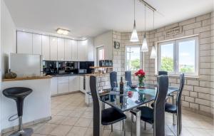 a kitchen and dining room with a table and chairs at Stunning Home In Kastel Novi With 3 Bedrooms, Private Swimming Pool And Outdoor Swimming Pool in Kaštela