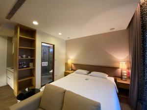 Postel nebo postele na pokoji v ubytování AJ Residence 安捷國際公寓酒店