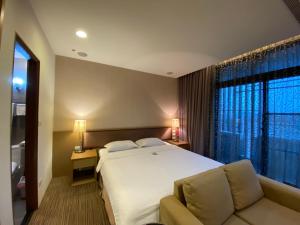 Postel nebo postele na pokoji v ubytování AJ Residence 安捷國際公寓酒店