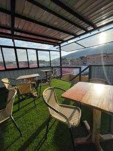 a patio with tables and chairs on a roof at Hotel Neblina Calima in Calima