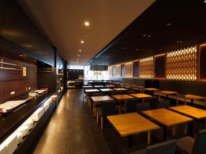a dining room with wooden tables and benches at Hiroshima Washington Hotel in Hiroshima