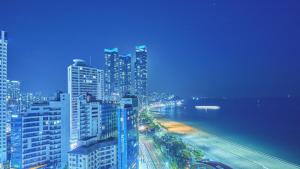 a view of a city at night with buildings at Kolon Seacloud Hotel in Busan