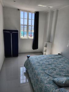 a bedroom with a bed and a window at THE VIEW APPARTMENTS in Willemstad