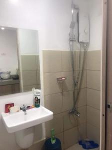 a bathroom with a shower and a sink at Watanabe Condo Unit in Pasong Bayog