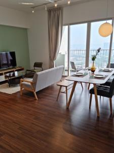 a living room with a couch and a table at Una Residence by Maya in Kuala Lumpur