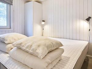 a bedroom with two white pillows on a bed at Holiday home Aakirkeby XLIV in Vester Sømarken