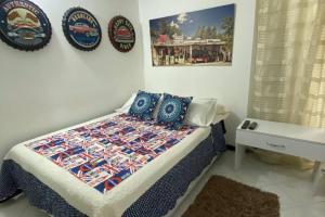 een slaapkamer met een bed met een quilt bij Apartamento de 4 Habitaciones Éxito de Laureles in Medellín
