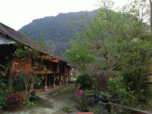 uma casa com uma montanha ao fundo em Mận Homestay - Lục Yên Homestay and Tour 