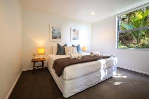 a bedroom with a large bed and a window at Bellevue in Onetangi