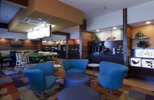 a restaurant with blue chairs and a table at Wingate by Wyndham Gurnee in Gurnee