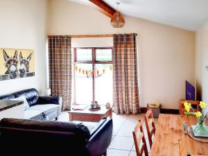 a living room with a couch and a table at Plough Cottage in Anderby