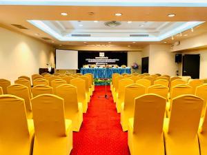 a conference room with yellow chairs and a red carpet at Princeton Bangkok in Bangkok