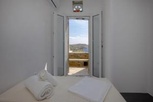 a bedroom with a bed and a window with a view at GL Villa in Agios Romanos