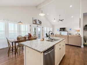 a kitchen with a sink and a table in a room at Port Royal Dream in City-by-the Sea