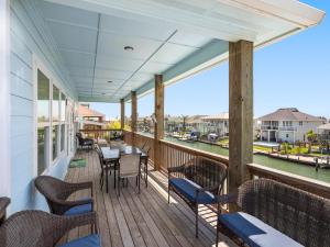 a balcony with tables and chairs and a view of the water at Port Royal Dream in City-by-the Sea