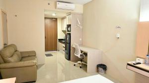 a living room with a desk and a chair in it at Nagoya thamrin apartment (Favehotel Building) in Nagoya