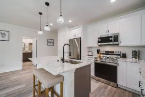 a large kitchen with white cabinets and a counter top at Family Villa King Bed, 3 bedrooms 2baths, 7 guests, Close to Beaches, Golfing, Fishing in Rotonda West