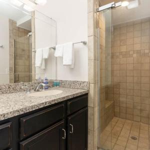 a bathroom with a shower and a sink and a mirror at Scenic Skyline View-Downtown in Cincinnati