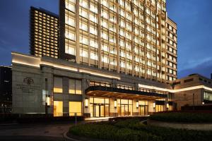 a large building with lights on in front of it at Metropolitan Residence in Shanghai