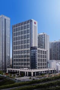 a large building in a city with tall buildings at Metropolitan Residence in Shanghai