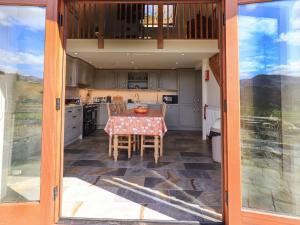 a kitchen with a table with a table cloth at The Stables in Ambleside
