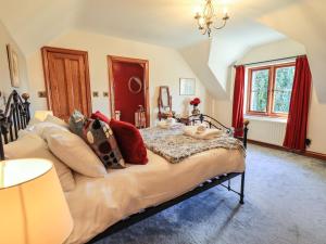 a bedroom with a bed with pillows on it at The Stables in Ambleside