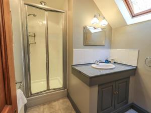 a bathroom with a sink and a shower at The Stables in Ambleside +45 photos