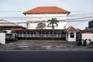 a building with motorcycles parked in front of it at Hippo Diving Bali Rooms in Sanur