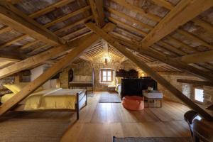 a bedroom with a bed in a room with wooden ceilings at Una in Kranjčići - Haus für 5-6 Personen in Svetvinčenat