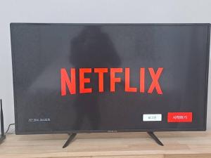 a television screen with the netflix sign on it at Two bedroom Apt Hongik University in Seoul