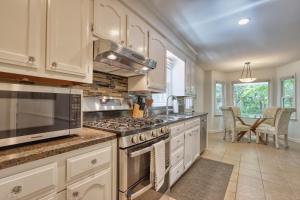 a kitchen with white cabinets and a stove top oven at Lake Murray Retreat in Lexington