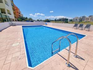a swimming pool on the side of a building at Seaside Heaven Apartment With Pool in Larnaca +3 photos