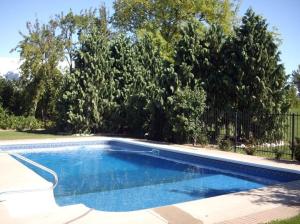 a swimming pool in a yard with trees at A La Gallarie in Niagara-on-the-Lake