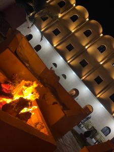 a traffic light with a fire in front of a building at amzran hotel siwa in Siwa