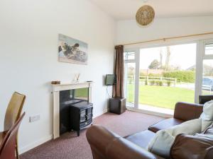 a living room with a couch and a fireplace at Chalet 150 in Great Yarmouth