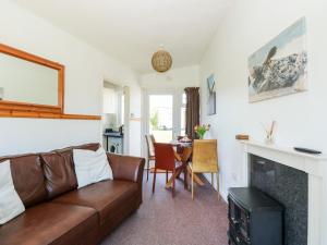 a living room with a couch and a fireplace at Chalet 150 in Great Yarmouth