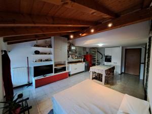 a kitchen with white cabinets and a table in a room at Casa Vacanze S.Tomaso in Riva del Garda