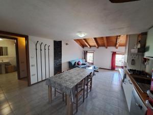 a kitchen and living room with a table and chairs at Casa Vacanze S.Tomaso in Riva del Garda +3 photos