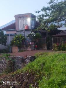 a house from the side of the road at Akria Bed and breakfast in Bayan