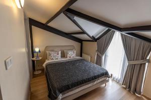 a bedroom with a bed and a large window at Calanthe Residence in Istanbul