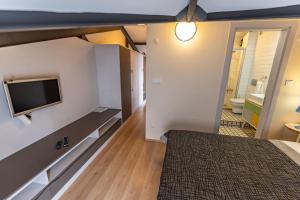 a bedroom with a bed and a flat screen tv at Calanthe Residence in Istanbul