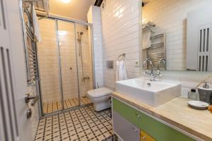 a bathroom with a sink and a toilet and a shower at Calanthe Residence in Istanbul
