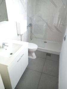 a bathroom with a sink and a toilet and a shower at Two person apartment in Nin